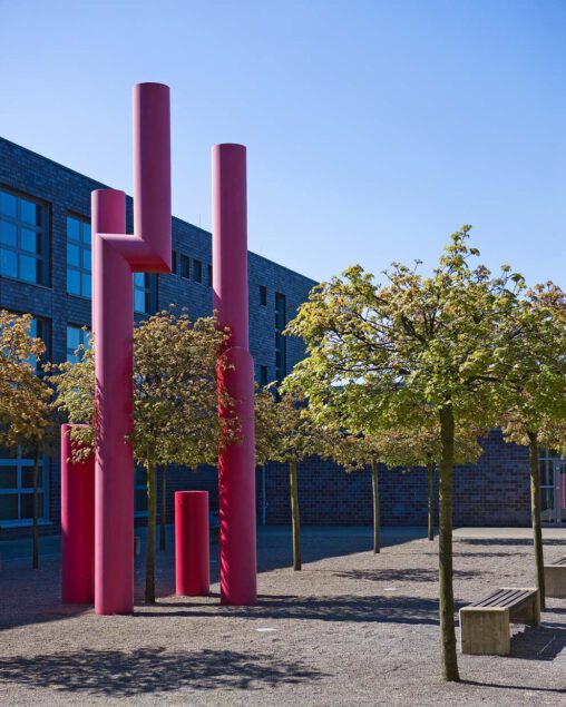 Friedrich Gräsel, Säulen für eine Akademie 2001, Bochum, Skulptur aus drei roten, unterschiedlich, grossen verwinkelten Stahlsäulen